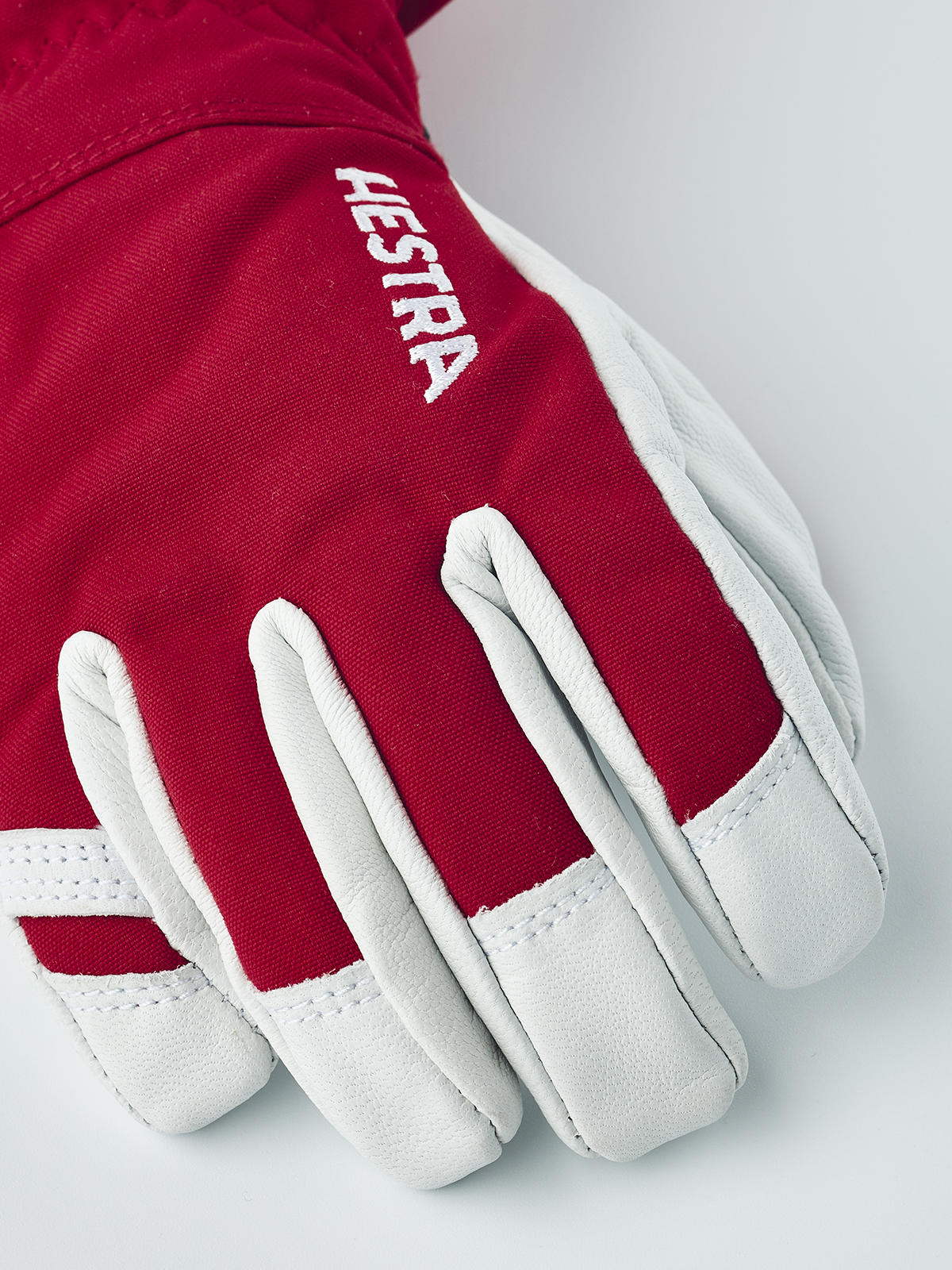 Kids ski gloves in red with white leather palms and white HESTRA logo