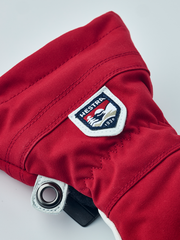 Red ski junior glove with HESTRA patch and wrist snap tab