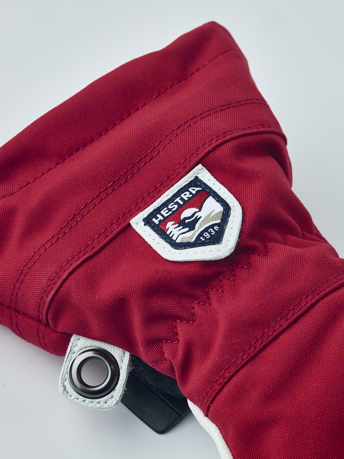 Red ski junior glove with HESTRA patch and wrist snap tab