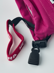 Kids ski gloves in fuchsia with white palms, black cuff strap, and red inner trim
