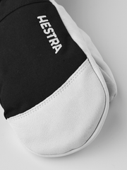 Hestra junior ski glove with black cuff, white palm, and HE ST RA text