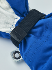 Blue junior ski gloves with white leather palm and black Hestra wrist strap