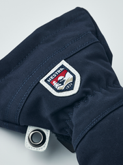 Junior ski glove in navy with Hestra patch and metal eyelet on cuff