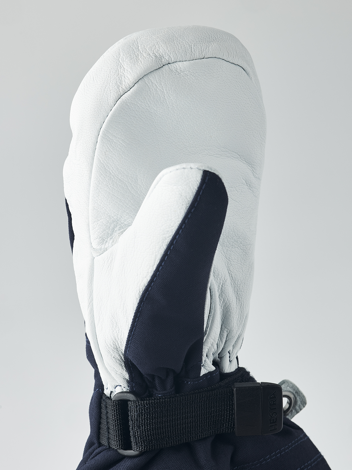 Junior ski glove in white leather with dark palm panel and black wrist strap