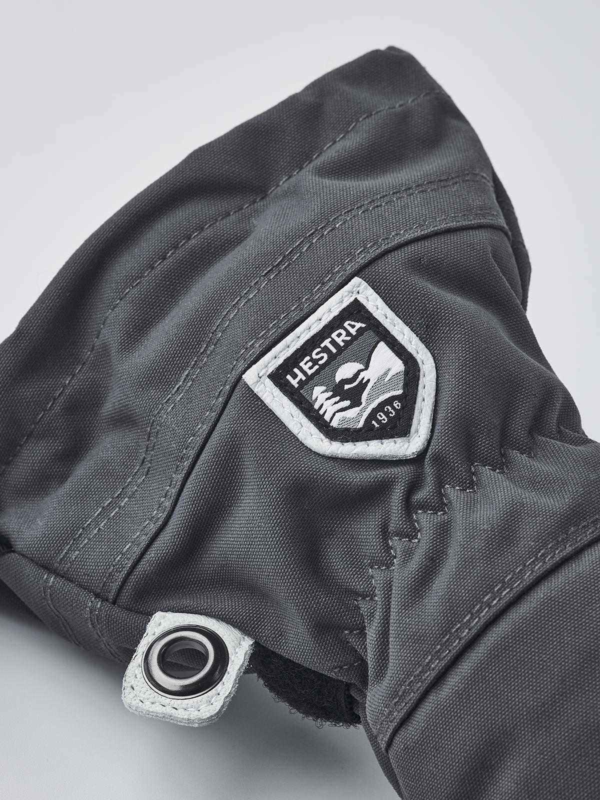 Hestra junior ski glove in dark gray/black with Hestra patch and wrist strap