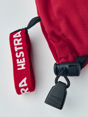 Kids Hestra ski mittens, red fabric with leather pull loop and brand tag