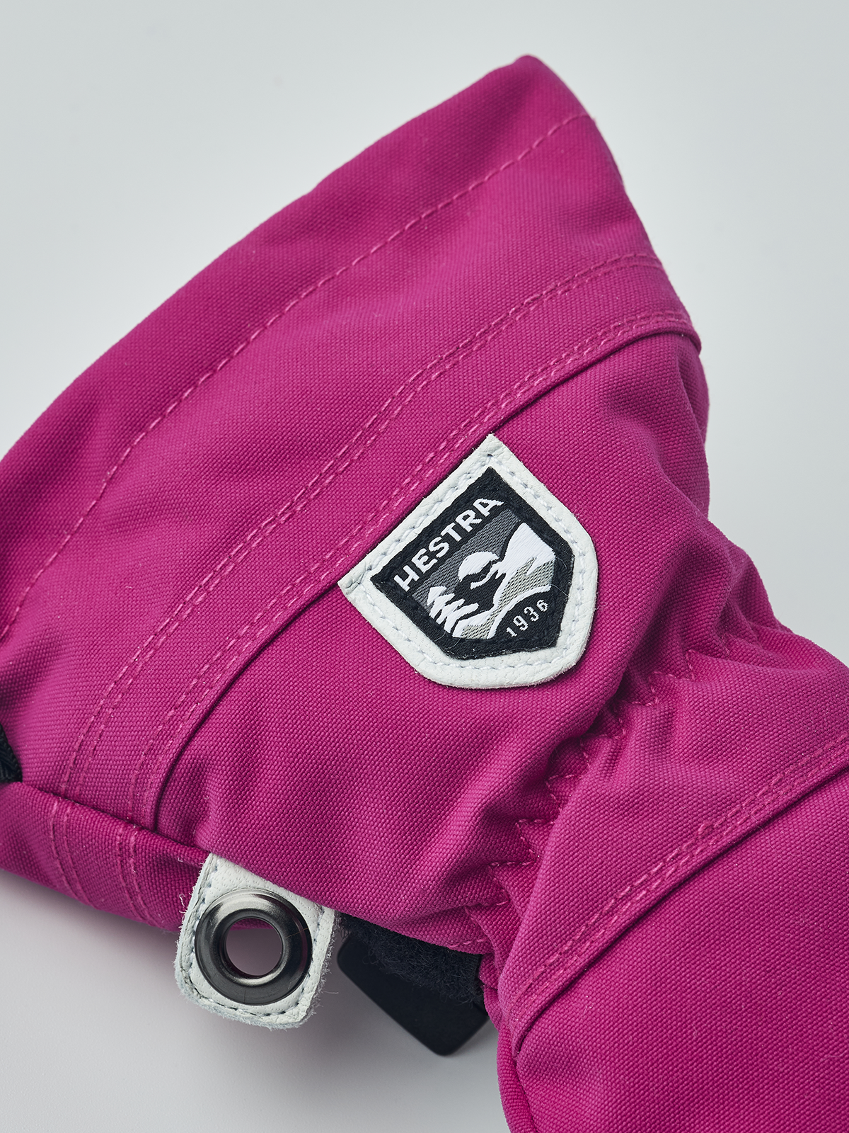 Kids ski mitten in magenta with white-edged HESTRA patch and metal snap wrist tab