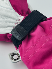 Kids ski mittens with magenta fabric, white leather palm, and black adjustable strap