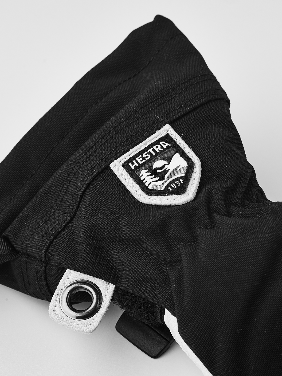 Junior ski glove in black with white Hestra patch and snap wrist strap
