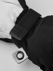 Hestra junior ski mitten close-up with black wrist strap and Hestra logo label