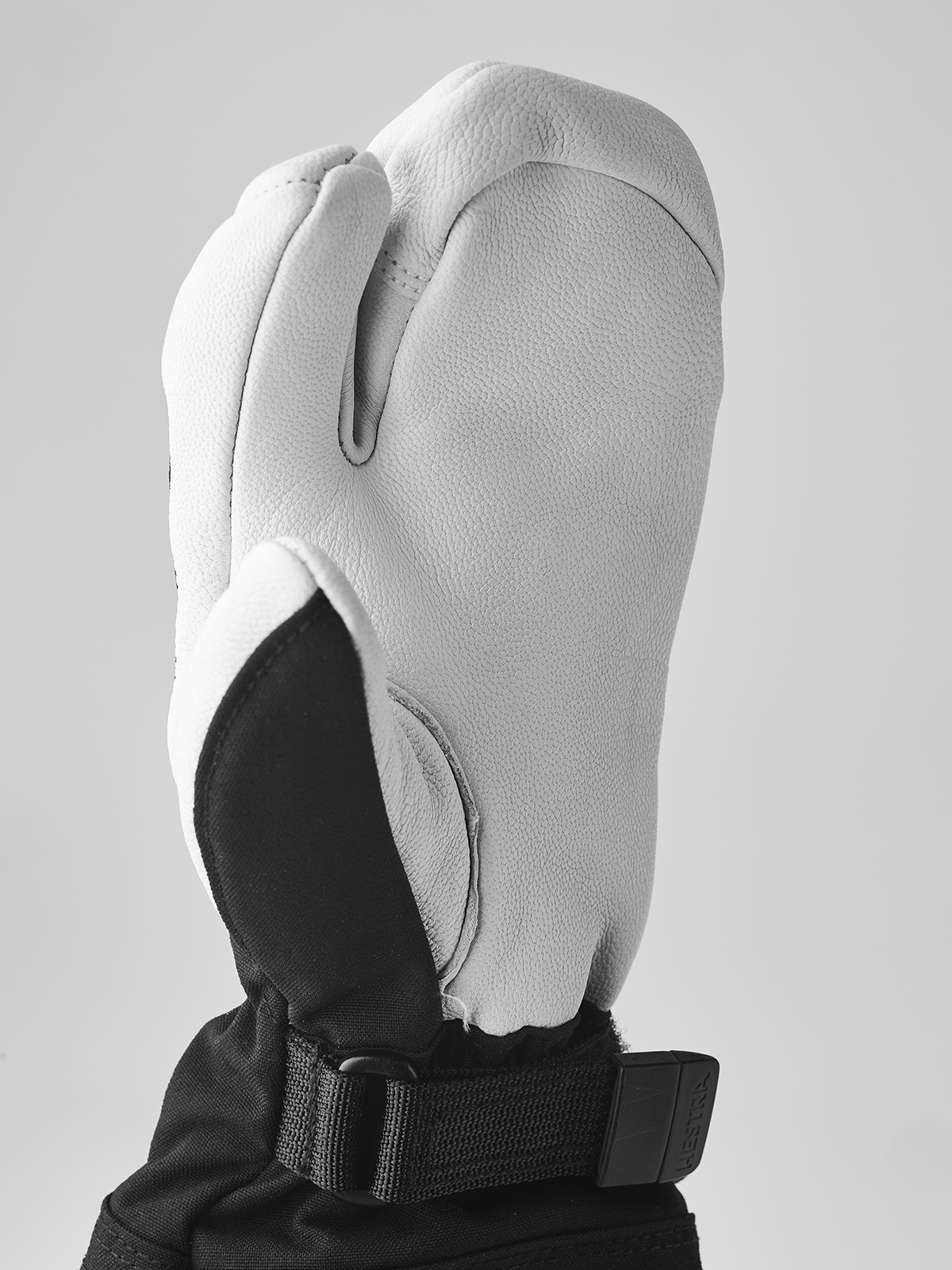 Hestra junior mittens in white leather-look with black side panel and wrist strap