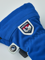 Junior ski gloves in royal blue with Hestra 1936 patch and metal grommet