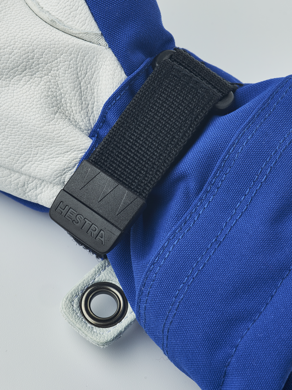 Hestra junior ski gloves in royal blue with black hook-and-loop wrist strap and ring detail