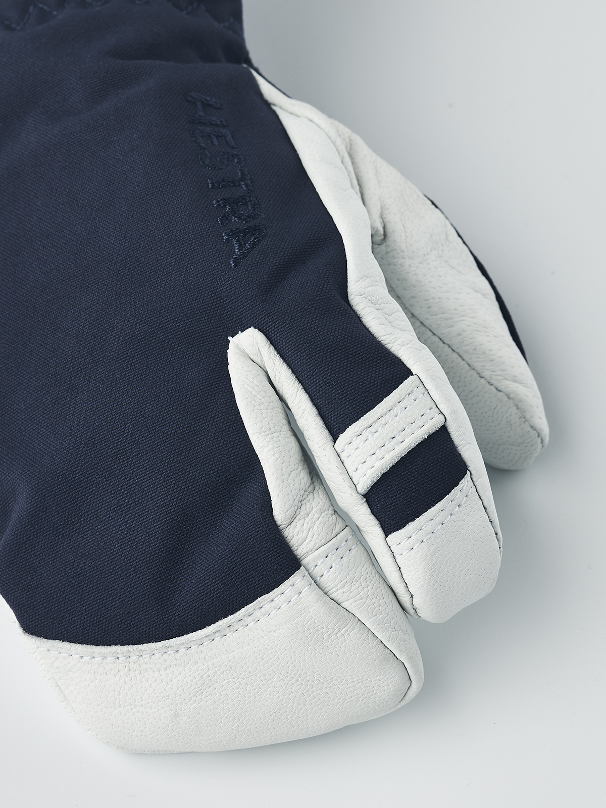 Hestra junior ski mittens in navy with white leather palm and stitched contrast finger panel