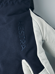 Junior ski glove in navy with embossed “HESTRA” text and white leather finger panel