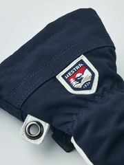 Hestra junior ski mittens in navy with Hestra logo patch and metal eyelet ring