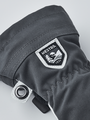 Hestra junior ski gloves in dark gray with Hestra logo patch and metal eyelet ring