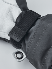 Junior ski gloves with black wrist strap, embossed Hestra patch and metal grommet
