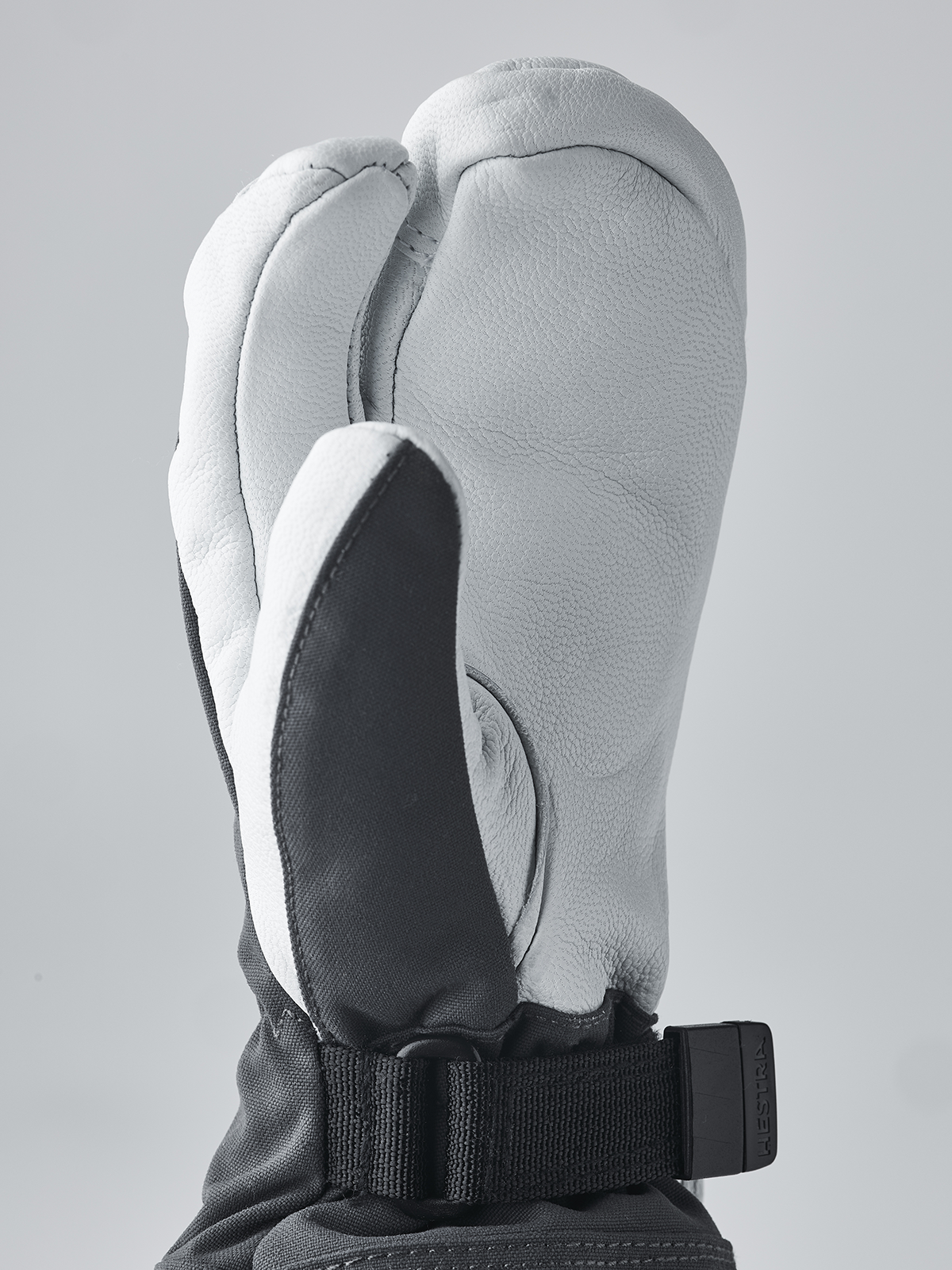 Hestra junior ski mittens in light gray with black inner palm panel and adjustable wrist strap