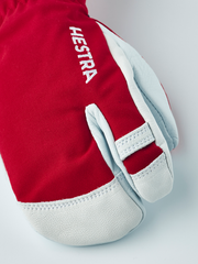 Junior ski glove in red with white leather palm and white “HESTRA” logo patch