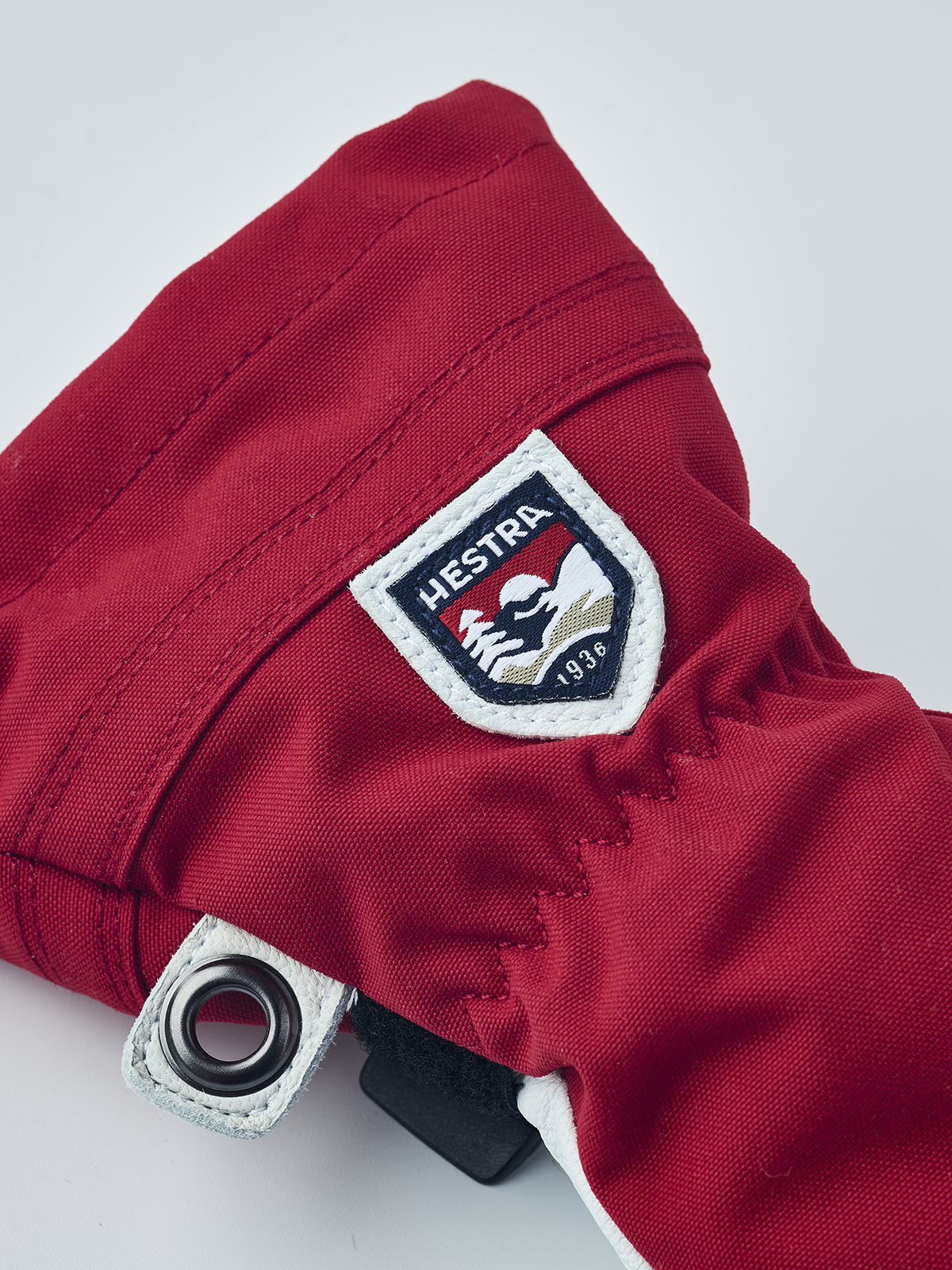 Red junior ski gloves with Hestra logo patch, leather palm and adjustable cuff