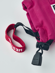 Fuchsia junior ski mitten with Hestra tag, black pull clip, and red wrist loop