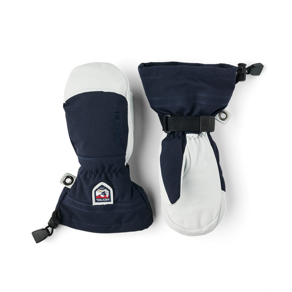 Pair of Hestra junior ski gloves with navy and white panels, wrist straps, and pull tabs