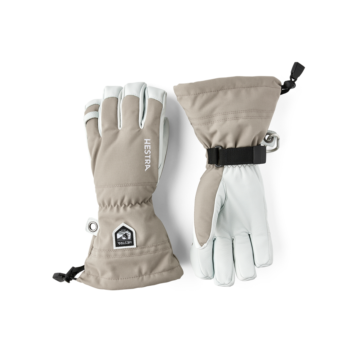 Light taupe ski gloves with leather palm, side cuff strap and Hestra patch.