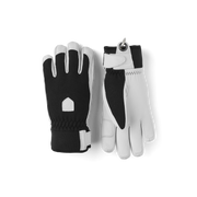 Pair of black-and-white winter patrol gloves with stitched knuckle panels and wrist loop.