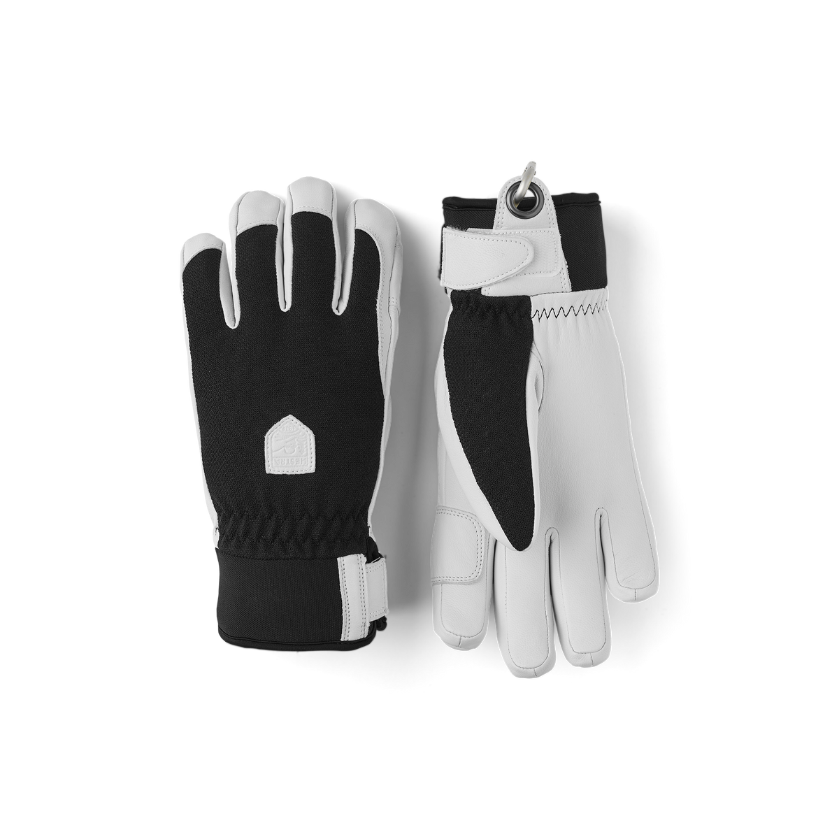 Pair of black-and-white winter patrol gloves with stitched knuckle panels and wrist loop.