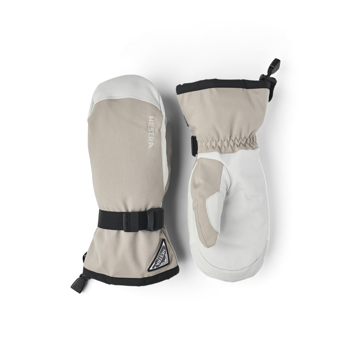 Beige and white powder gauntlet mittens set with black cuff strap and Hestra logo