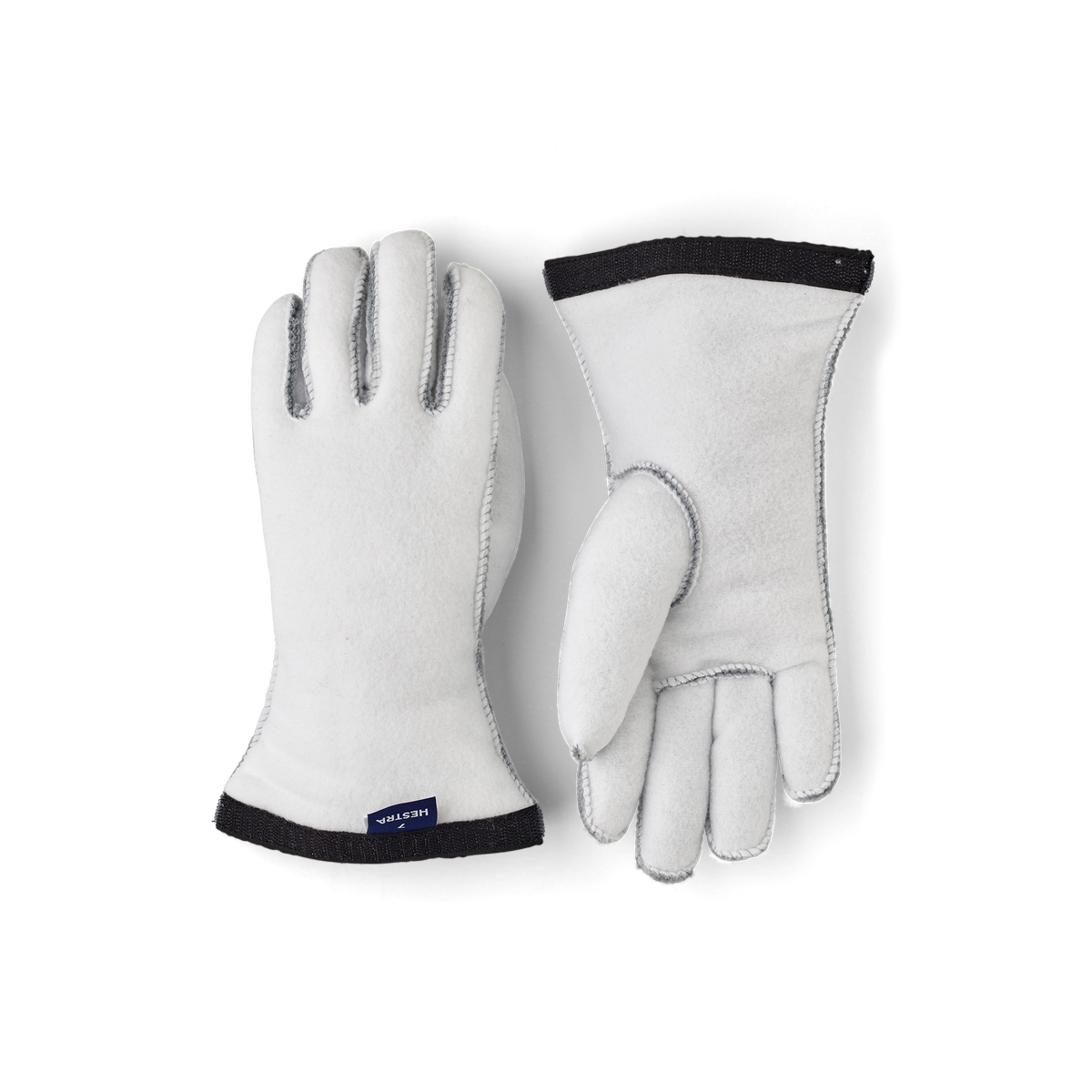 Off-white ski glove liners with black cuffs and finger tops