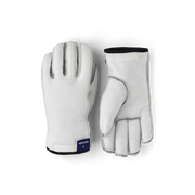 Off-white glove liners with five fingers, gray stitching, and black wrist cuff
