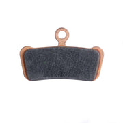 Dark disc brake pad with metal backing and mounting hole for rotor contact