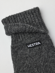 Grey knit mitten liner with ribbed cuff and HESTRA logo patch.