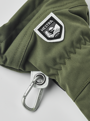 Olive ski glove with HESTRA shield patch and metal carabiner ring