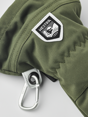 Green ski mitten with Hestra patch and carabiner clip on the cuff