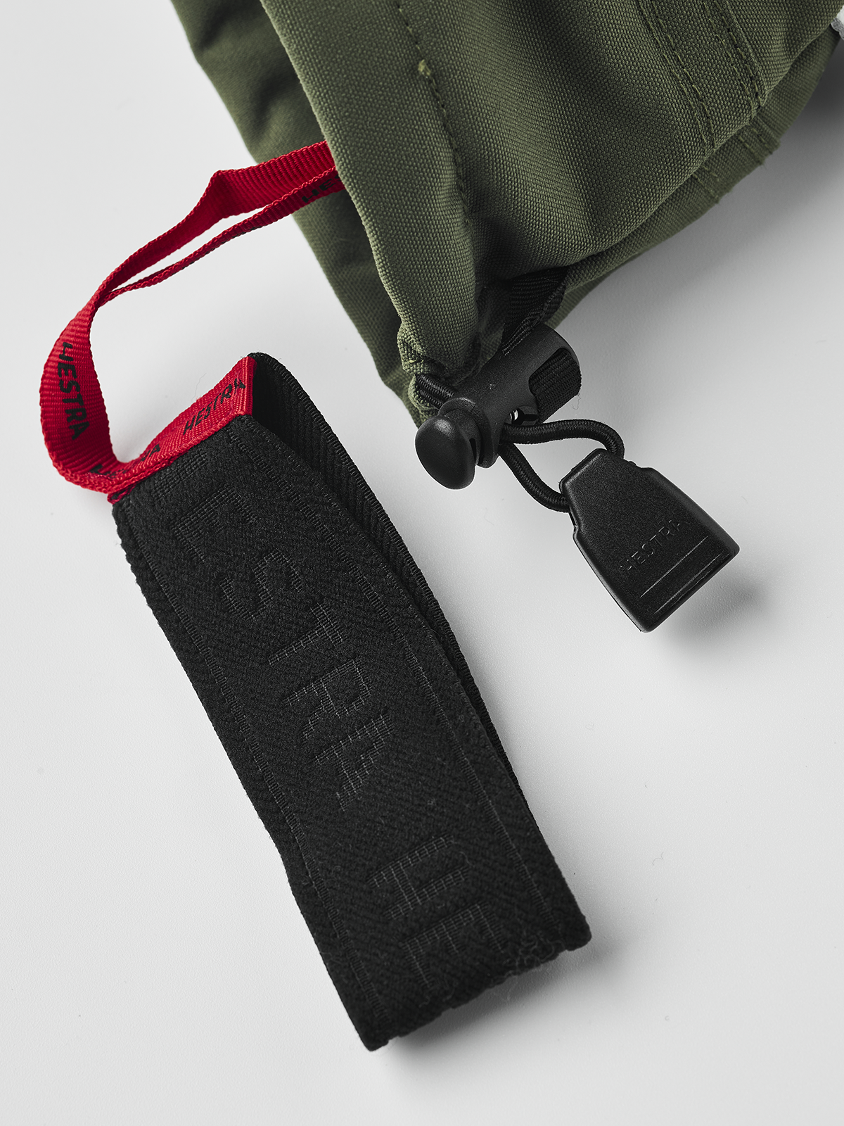 Olive green 3-finger ski gloves with black wrist strap and key clip