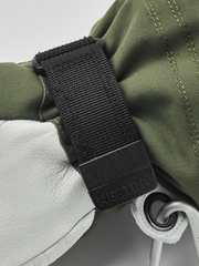 Hestra women’s Heli ski gloves in olive green with black wrist strap and padding detail