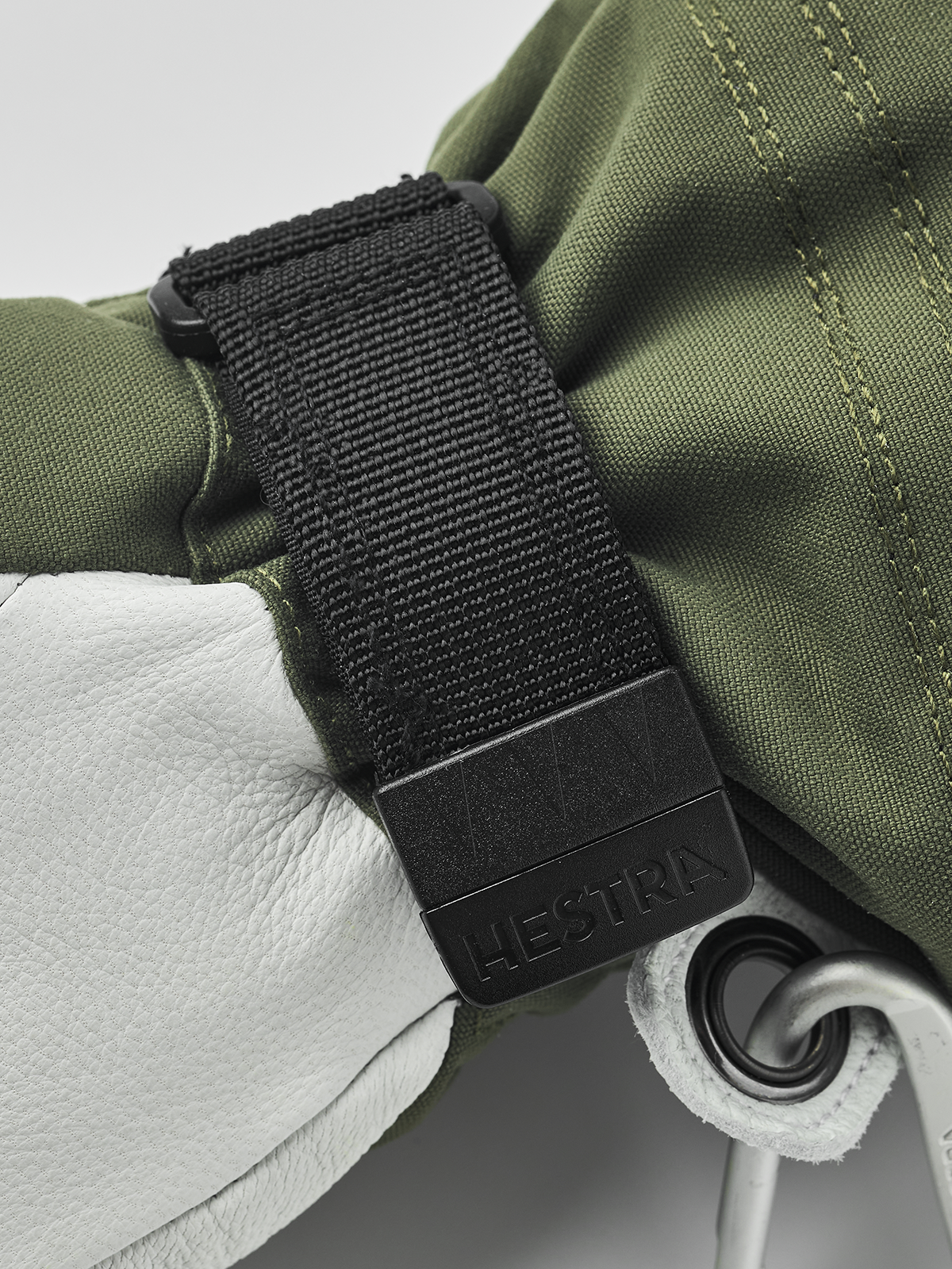 Hestra women’s Heli ski gloves in olive green with black wrist strap and padding detail