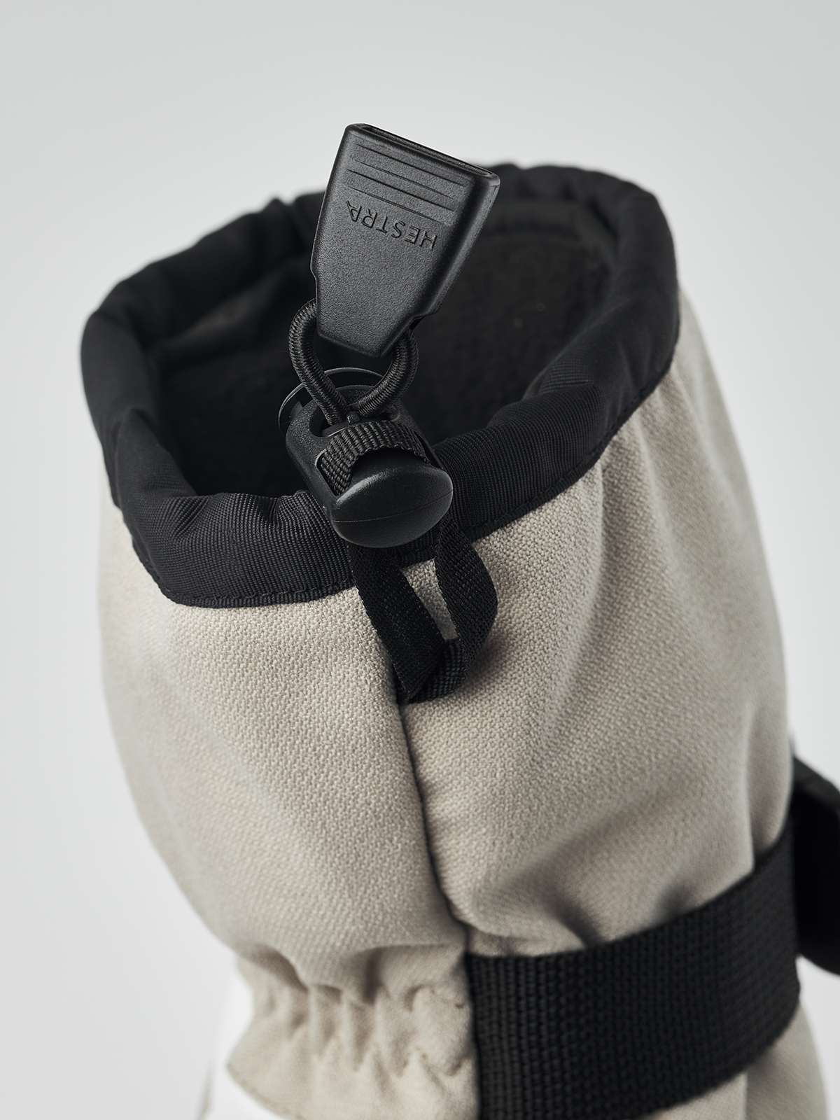 Black and beige powder gauntlet mitten with hanging toggle and elastic wrist cuff