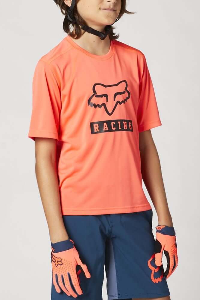 Youth short-sleeve jersey in coral with black FOX Racing logo on chest.