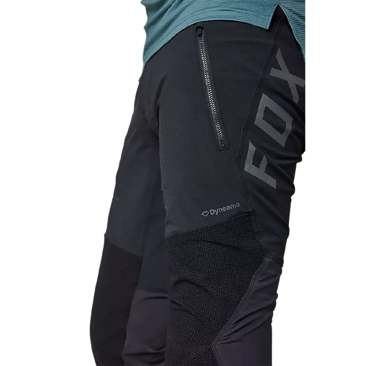 Fox Flexair Pro pant close-up: black abrasion panel with zipper and Dyneema logo