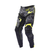 Youth riot pants in black with neon yellow accents and camo panels