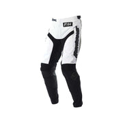 Youth motocross pants in white with black panels and knee armor, Fasthouse logo.