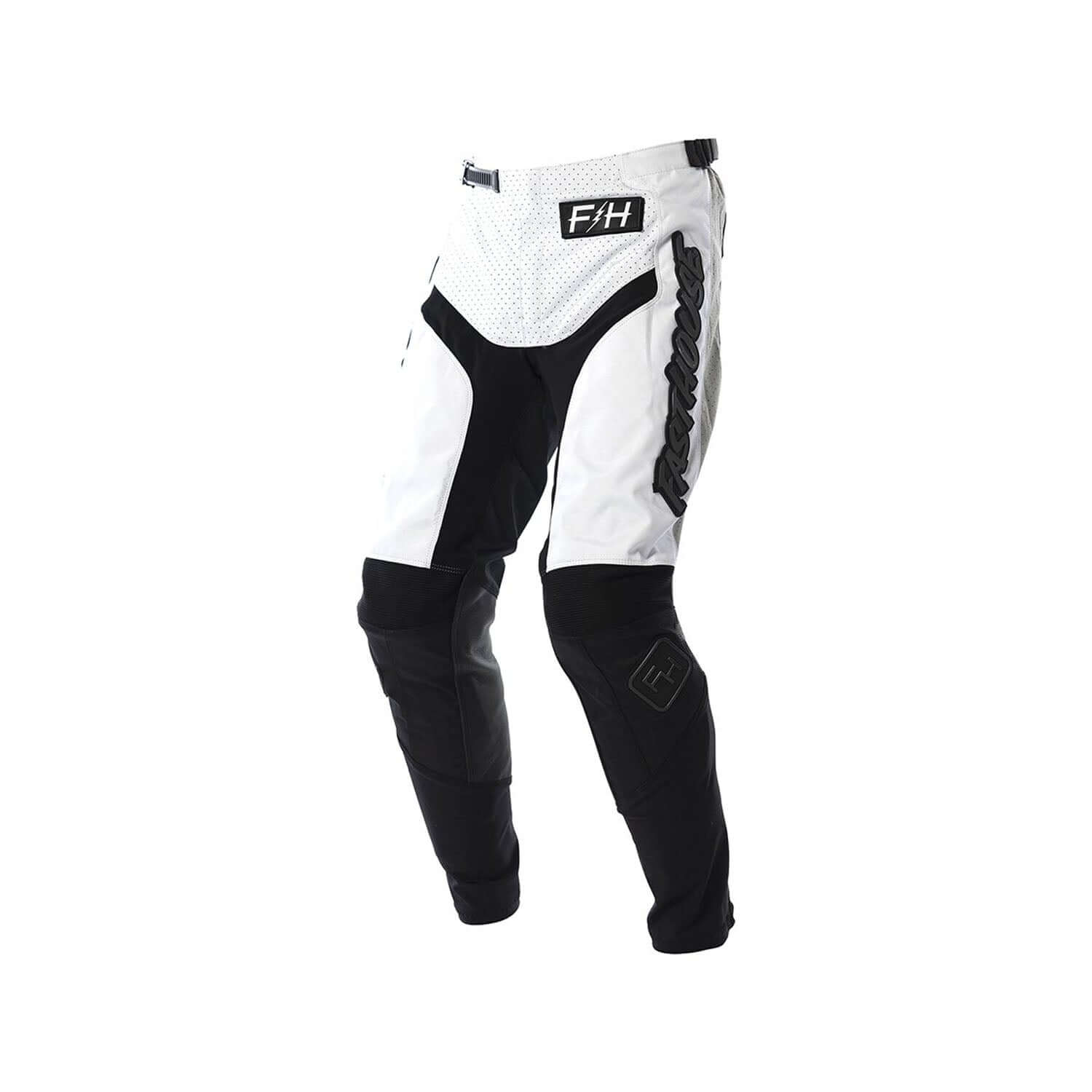 Youth motocross pants in white with black panels and knee armor, Fasthouse logo.