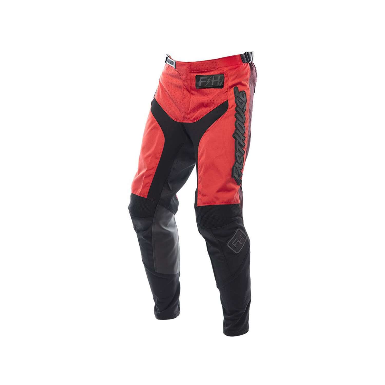 Youth motocross pants in red and black with padded knee panels, Fasthouse logos.