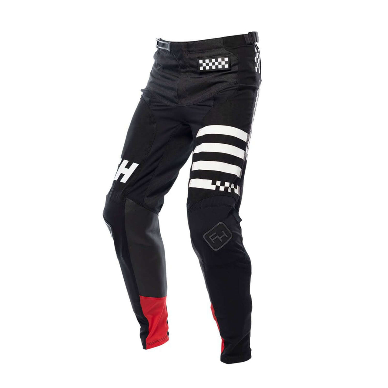 Black youth motocross pants with white checker logo and striped panels, red knee trim