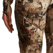 Hunting pants close-up of camo thigh panel with utility pocket and adjustable strap