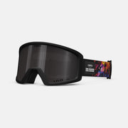 Snow goggles with black frame and dark lens; strap has colorful graphic design.